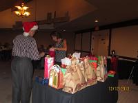IMG 3216  Gift exchange in progress...Greg and Paul orchestrate