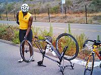8.2.07thursday02  Sam has flat in San Onofre State Park. No problem, he carries a spare sew-up! Other riders continue on.